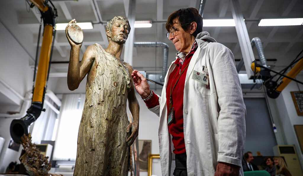 Stefania Colesanti recupera los fragmentos dañados de una estatua de madera