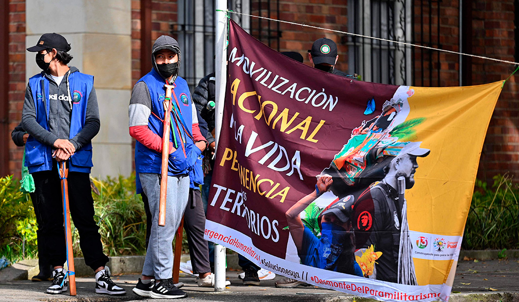 Miembros de la guardia indígena sostienen un cartel en la entrada de la Nunciatura Apostólica en Bogotá