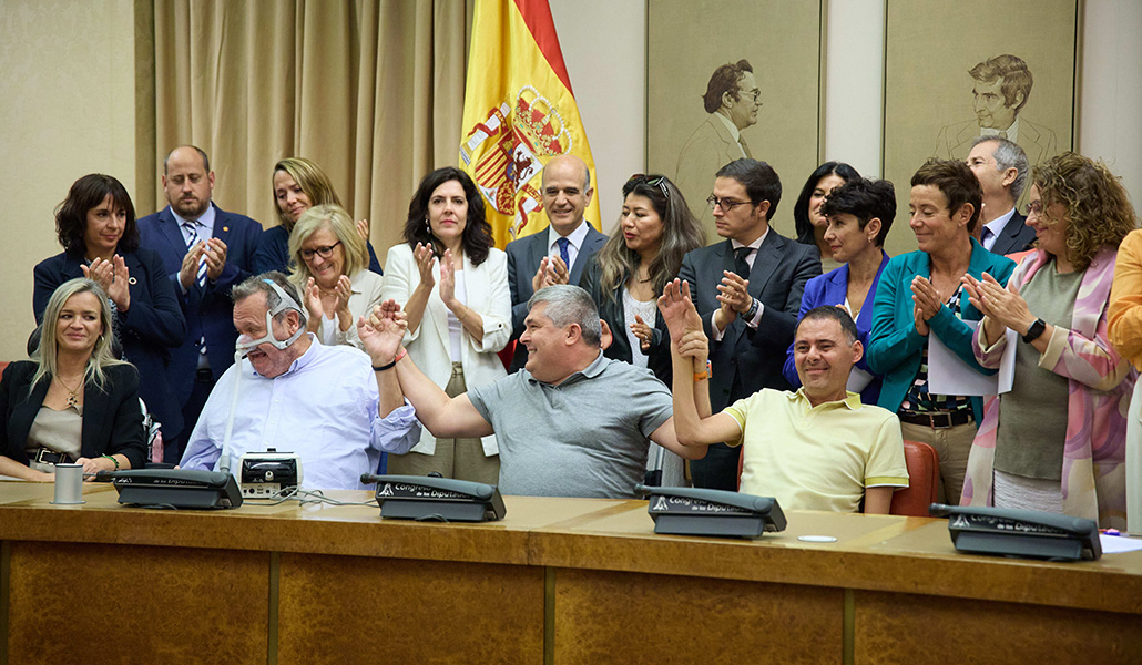 Varias personas con ELA celebran la firma del acuerdo en el Congreso de los Diputados