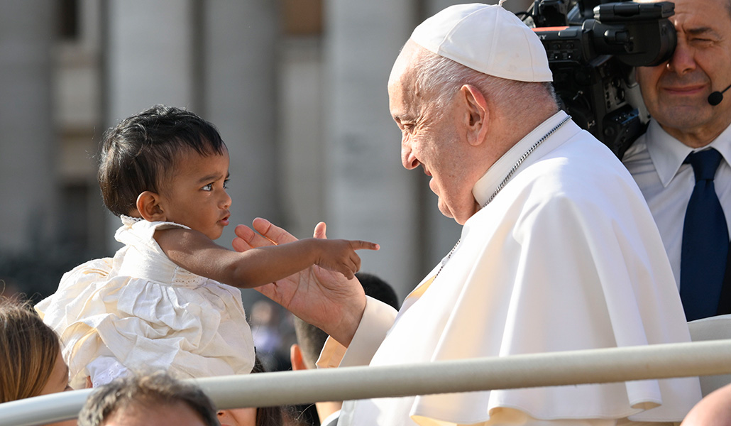 El Papa Francisco saluda a un niño pequeño mientras viaja en el papamóvil por la plaza de San Pedro en el Vaticano antes de su audiencia general semanal el 18 de septiembre de 2024