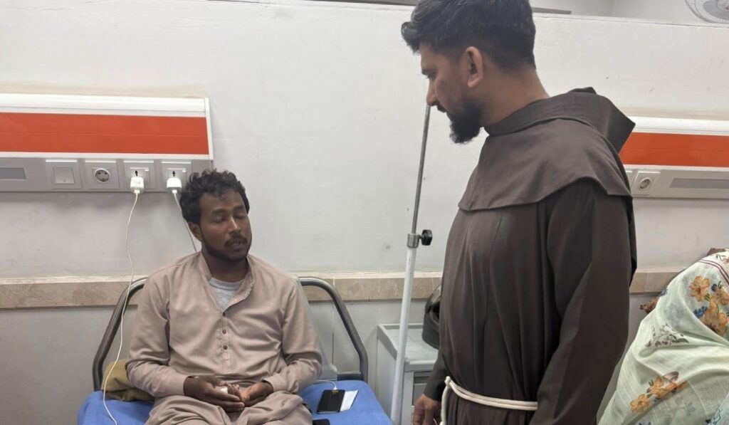 El sacerdote que acompañaba a la procesión, en el hospital con un herido. Foto: Lazar Aslam.