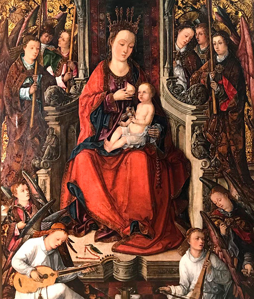 La figura central del retablo es una Virgen de la Leche dando el pecho al Niño Jesús.