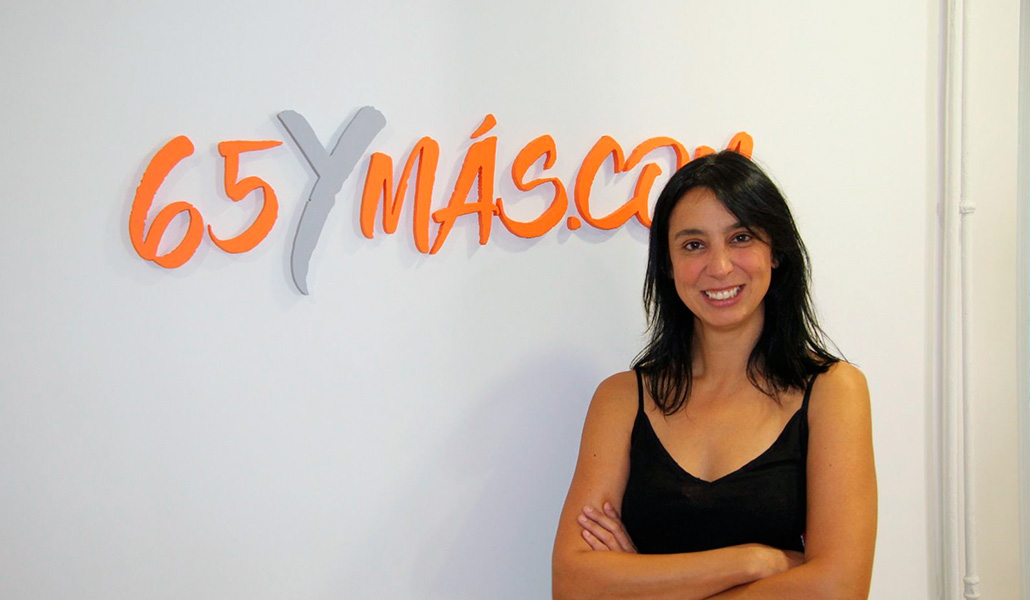 Ana Bedia delante del logotipo de 65ymas