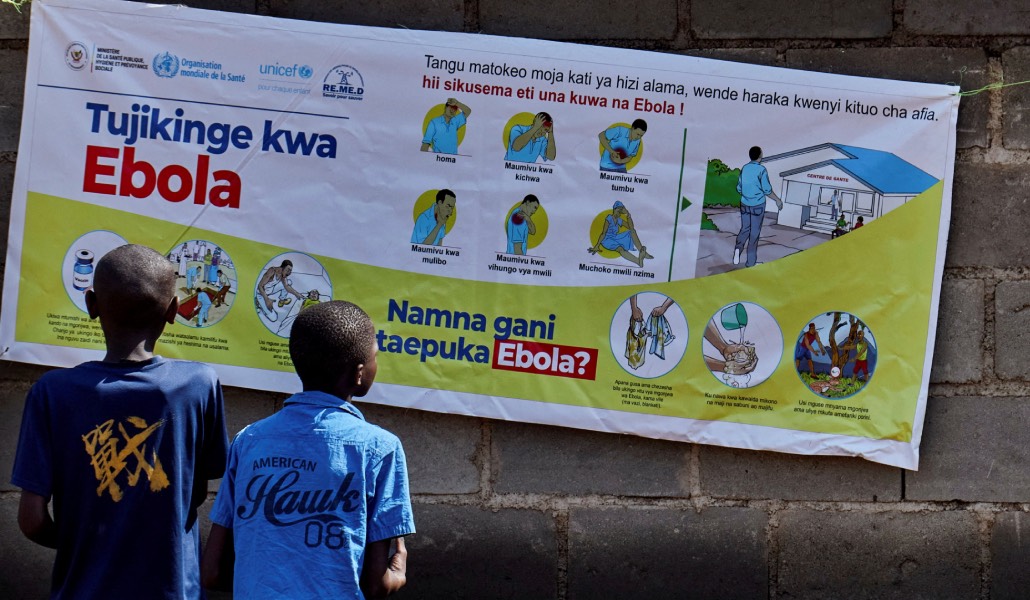 Niños miran un cartel con información sobre el ébola. Foto: OSV News / Reuters / Gradel Muyisa Mumbere.